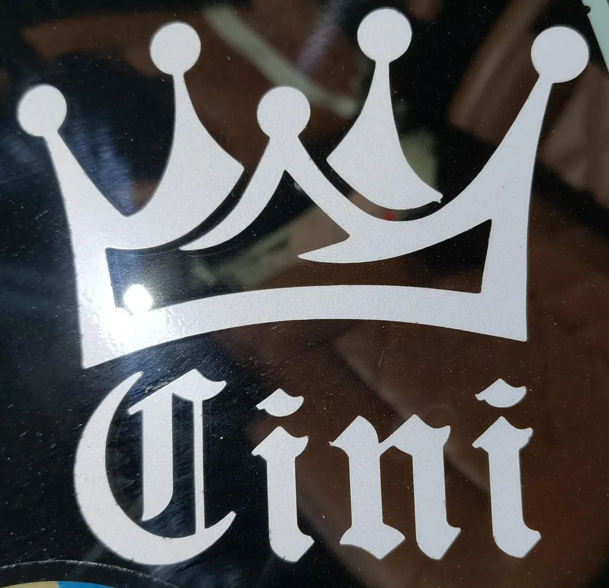 Cini crown decal on vehicle glass
