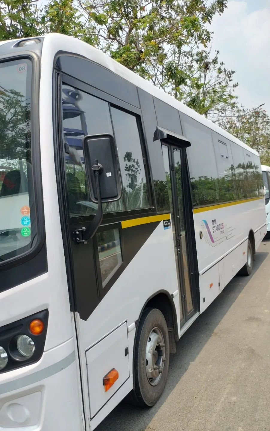 Side of a white mini bus with the passenger door open